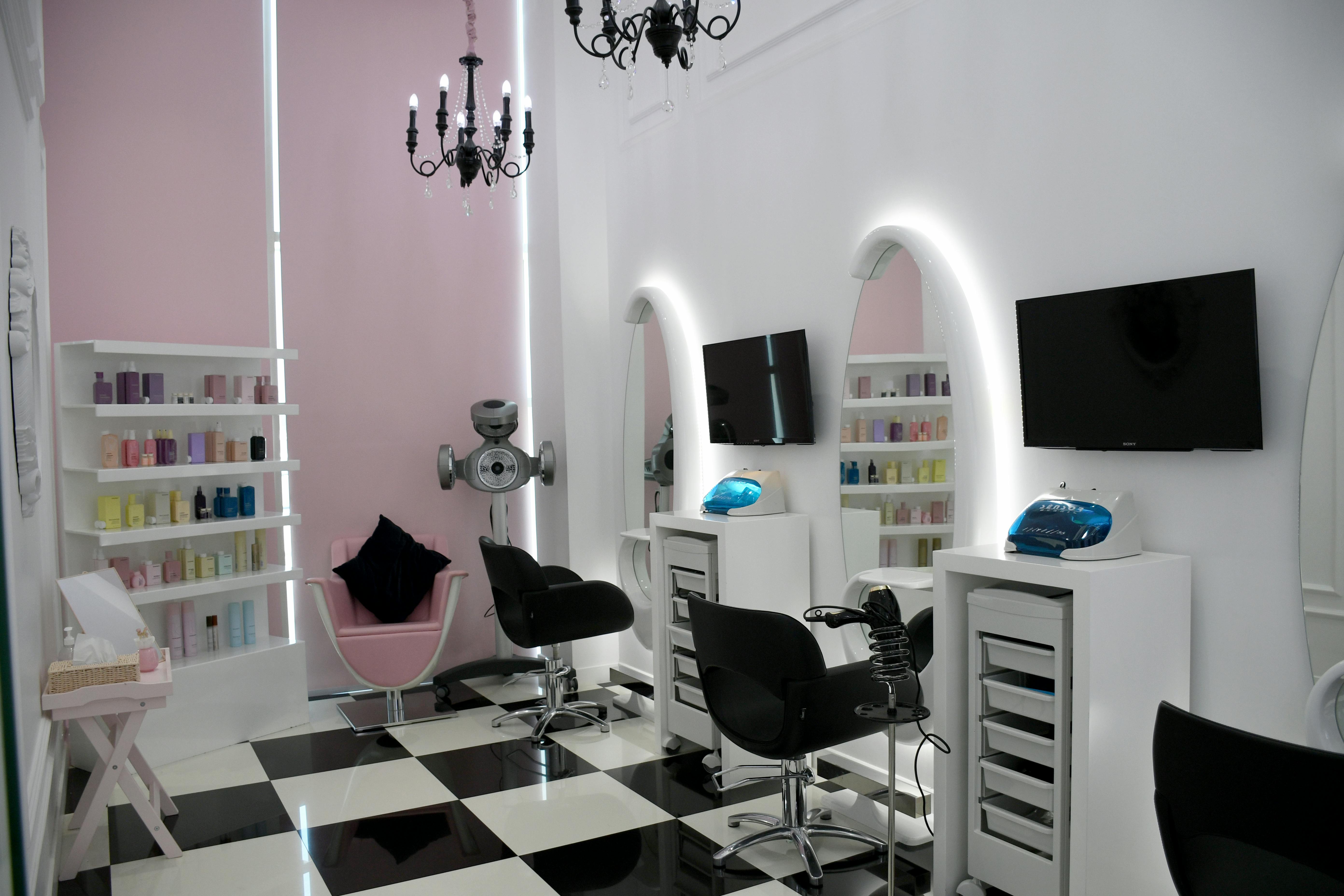 Afro hair stylist with braiding tools, representing professional pricing transparency