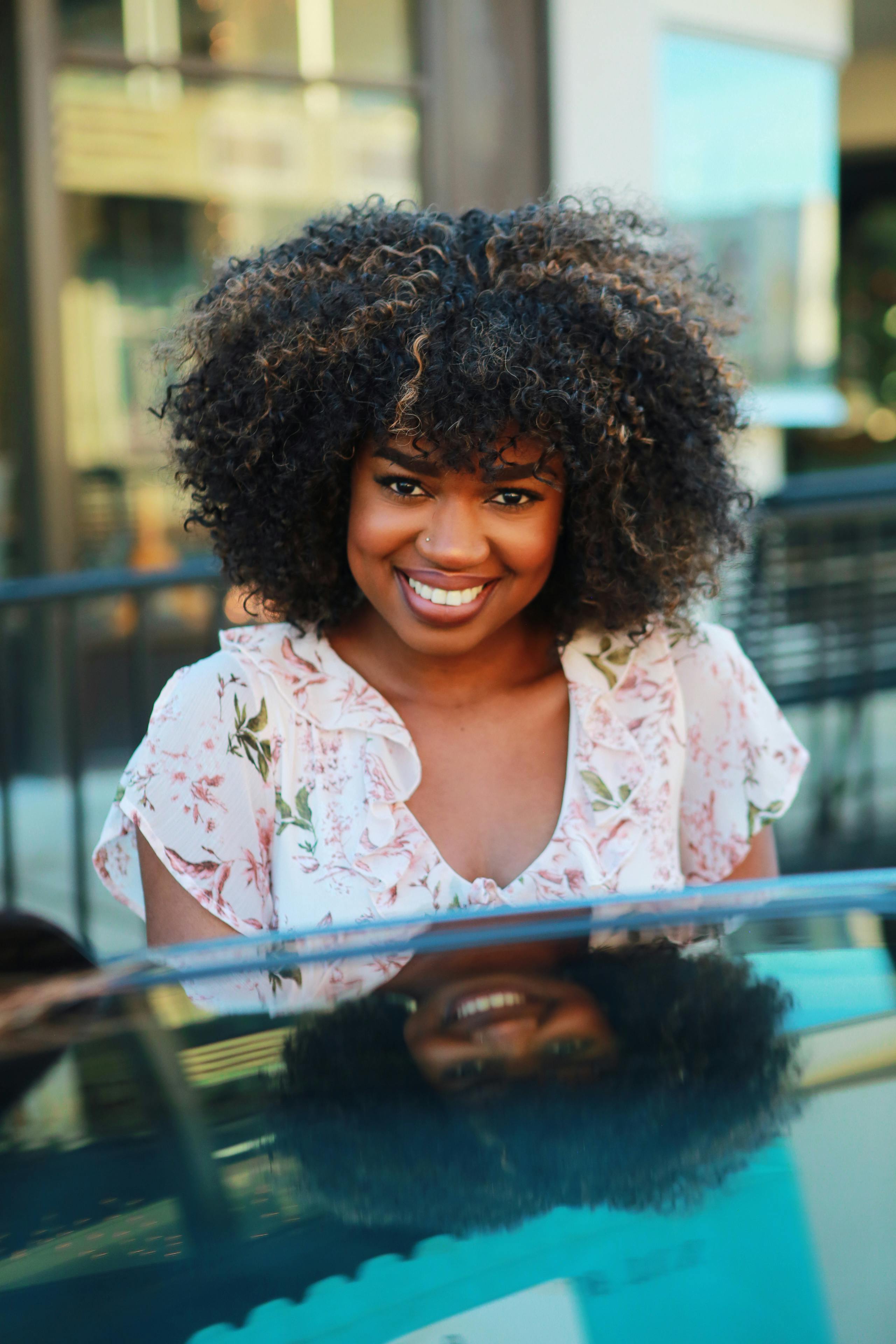 Woman with beautiful natural afro hair smiling confidently